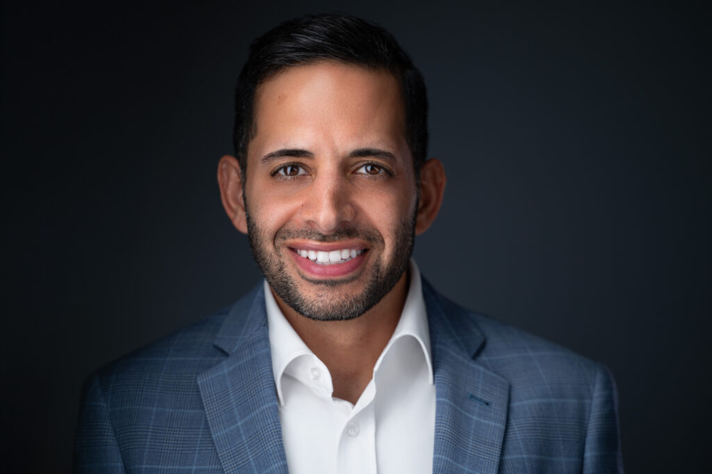 Nicholas Mukhtar, Tera Strategies founder, smiling in a blue plaid blazer