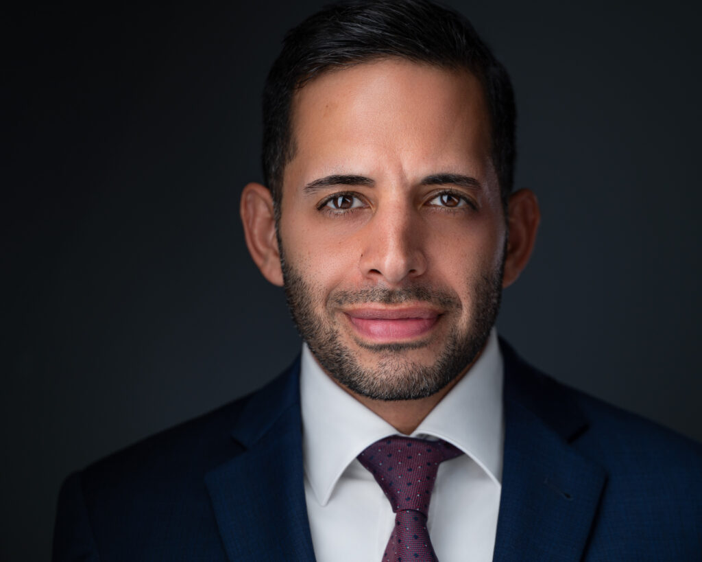 Nicholas Mukhtar, founder of Healthy Detroit, in a navy suit and maroon tie