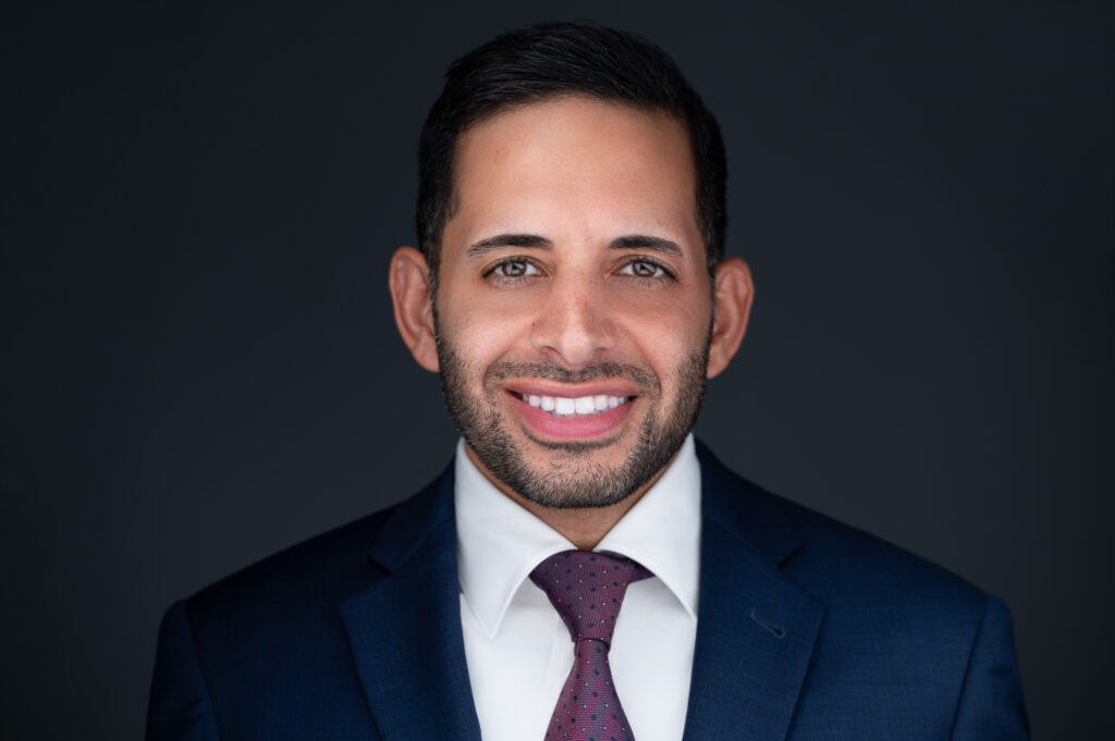 Nicholas Mukhtar, Johns Hopkins Bloomberg Fellow alumnus, in a navy suit